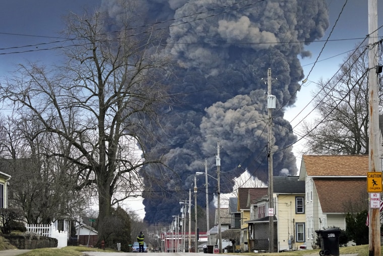 A black plume rises over East Palestine, Ohio, after a controlled explosion of a portion of the derailed Norfolk Southern trains