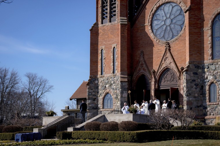 Clergy lead the casket out after the funeral for Brian Fraser in Grosse Pointe Farms, Mich. 