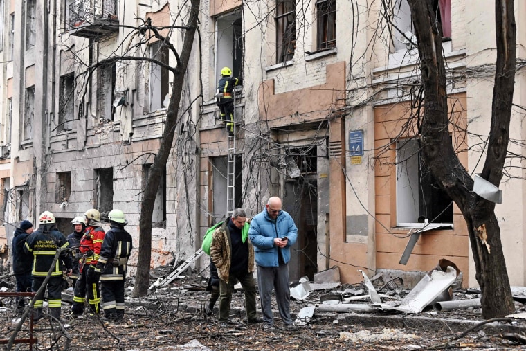 Rescuers work outside a building partially destroyed by a Russian missile strike in Kharkiv, Ukraine