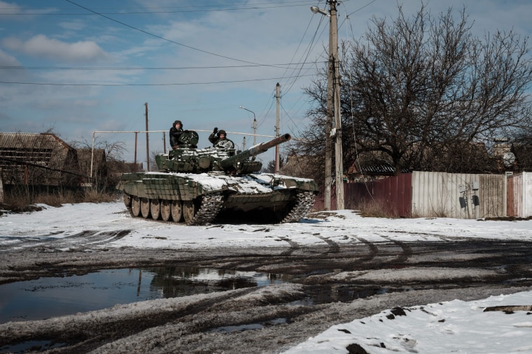 Ukrainian troops wave from a tank in the town of Siversk. 