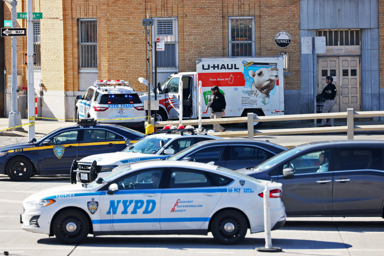 NYPD officers search a crashed U-Haul truck in Brooklyn, N.Y.