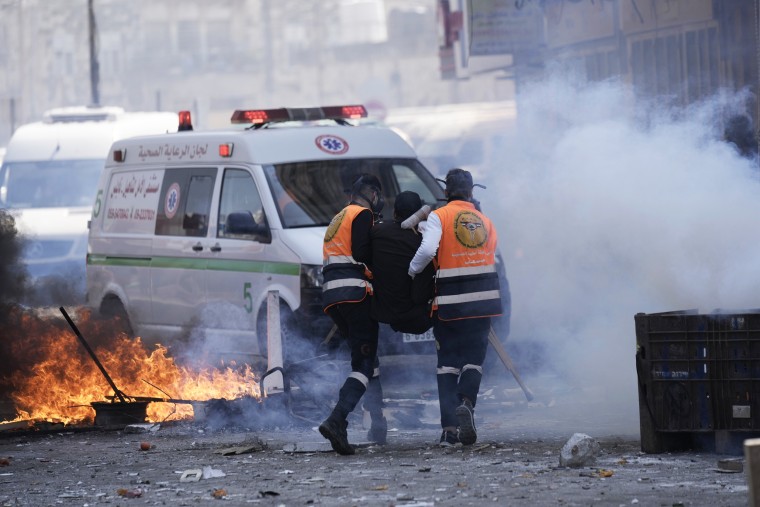 Medics evacuate a wounded Palestinian during clashes with Israeli forces in the West Bank city of Nablus