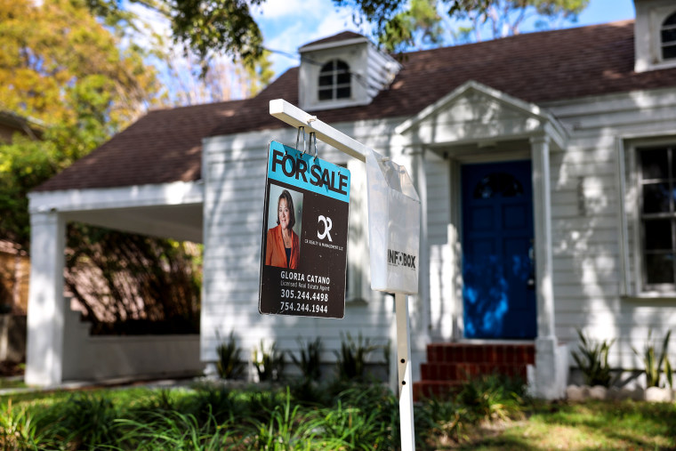A For Sale sign displayed in front of a home on Feb. 22, 2023 in Miami.