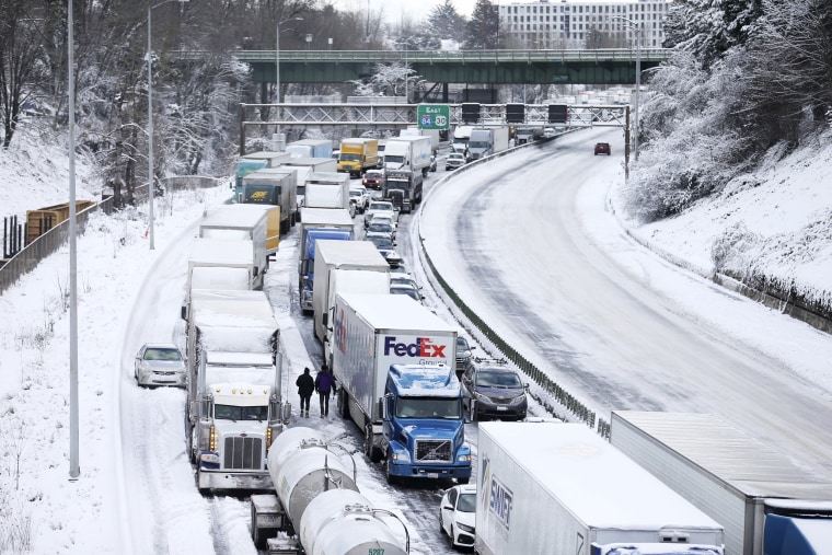 Cars and trucks backed up on Interstate 84 are seen from the Blumenauer Bicycle and Pedestrian Bridge in Northeast Portland, Thursday, Feb. 23, 2023.  Nearly a foot of snow fell in Portland on Wednesday.