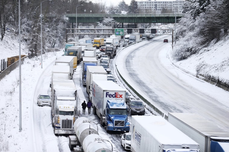 The backup of cars and trucks stuck on Interstate 84 is seen from the Blumenauer Bicycle and Pedestrian Bridge in Northeast Portland, Ore., Thursday, Feb. 23, 2023. Nearly a foot of snow fell in Portland on Wednesday.