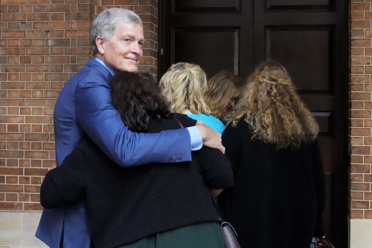 Steve Johnson, brother of U.S. murder victim Scott Johnson, hugs his wife, Rosemarie, as they arrive at the Supreme Court in Sydney on May 2 for a sentencing hearing in Scott's murder.