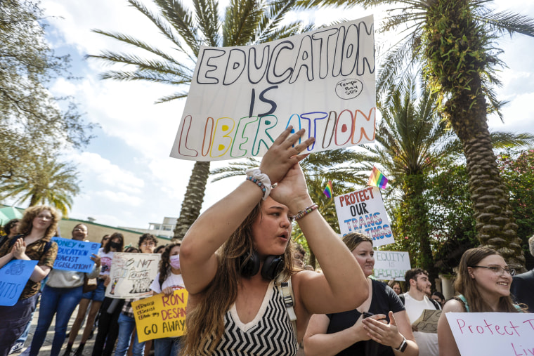 Image: Sophie Craig, 19, cheers during a gathering after University of South Florida students and faculty members join a statewide student walkout to protest Gov. Ron DeSantis' education policies at the Tampa campus on Feb. 23, 2023. 