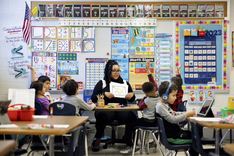 Image: Student teacher Lana Scott, who plans to graduate from Bowie State University in the spring of 2023, teaches a small group of kindergartners at Whitehall Elementary School the alphabet, on Jan. 24, 2023, in Bowie, Md. 