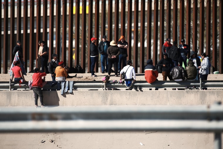 Migrants wait at the U.S.-Mexico border in Ciudad Juarez, Mexico