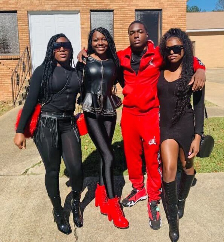 Jaylen Lewis with his sisters, Alexus Lewis, from left, Uneisha Lewis and Keia Lewis.