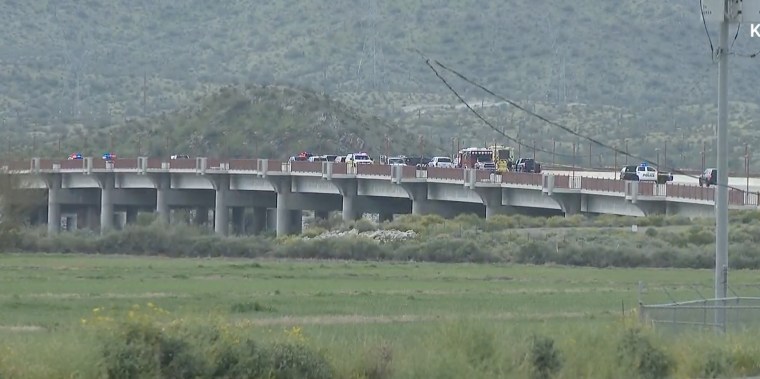 Emergency personnel work at the scene of a fatal crash on Cotton Lane Bridge in Goodyear, Ariz.