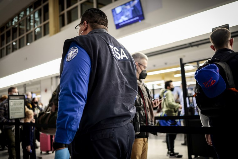 A TSA Officer watches people go through the security checkpoint at the Ronald Reagan Washington National Airport on Nov. 24, 2021 in Arlington, Va.