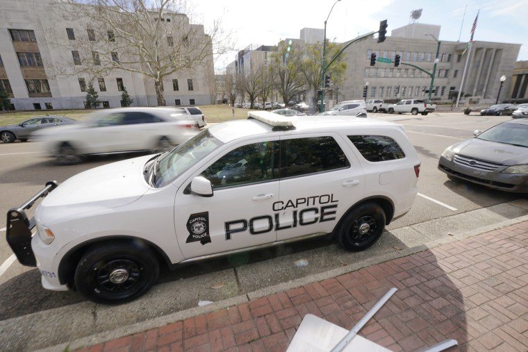 A Capitol Police SUV is parked across the street from the Hinds County Courthouse, left, and the main offices of the Jackson Police Department, right, in downtown Jackson, Feb. 13, 2023. (AP Photo/Rogelio V. Solis)