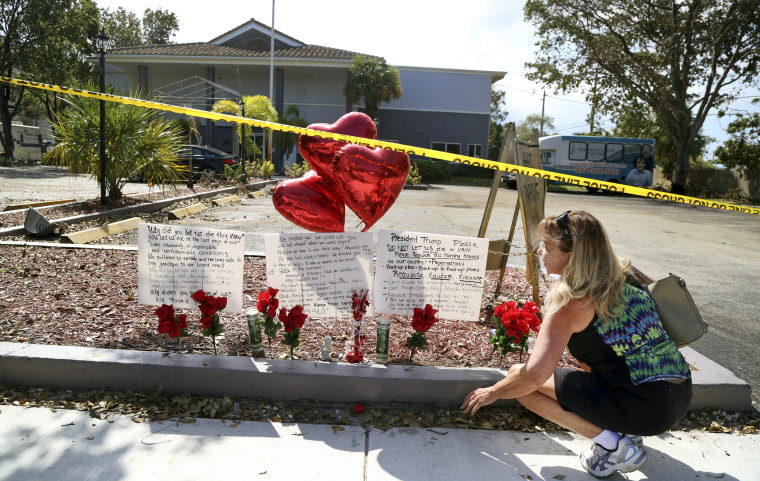 Janice Connelly sets up a makeshift memorial in memory of the senior citizens who died in the heat at the Rehabilitation Center at Hollywood Hills, Fla.