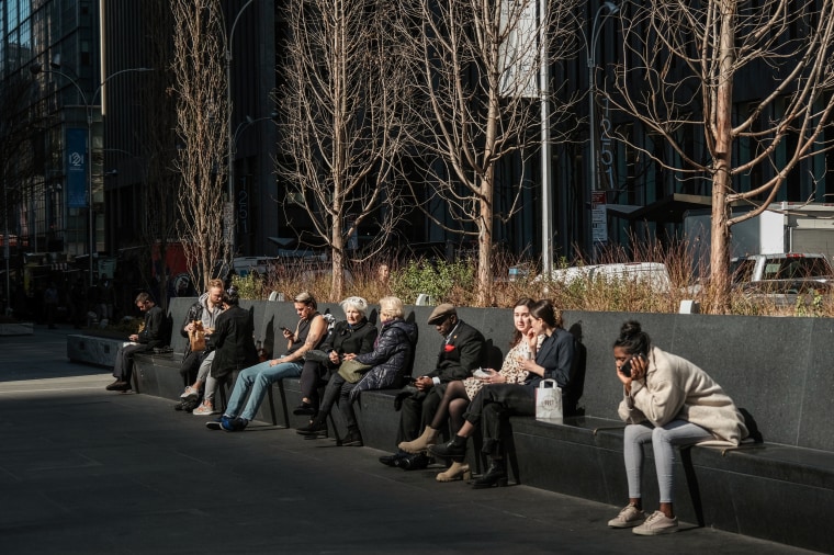 People relax in Manhattan on an unseasonably warm afternoon on Feb. 15, 2023 in New York.