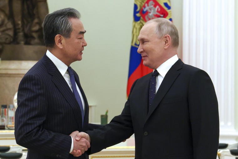 Putin saluda a Wang en Moscú el 22 de febrero.