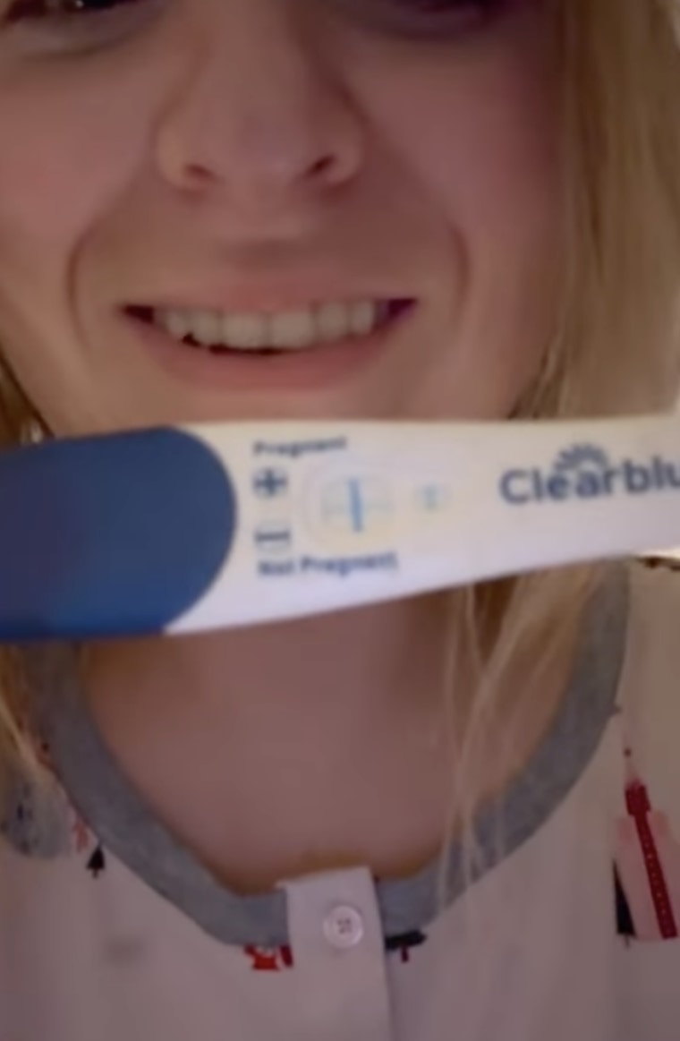 Meghan Trainor holds up her pregnancy test