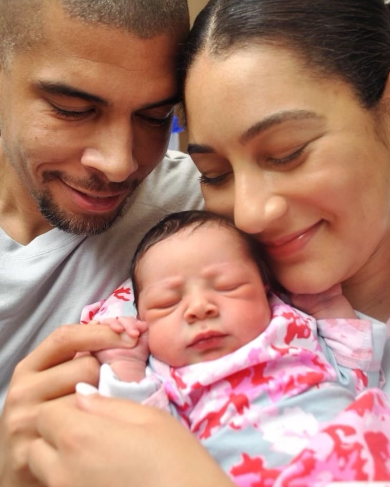 Morgan Radford and David Williams with their daughter.