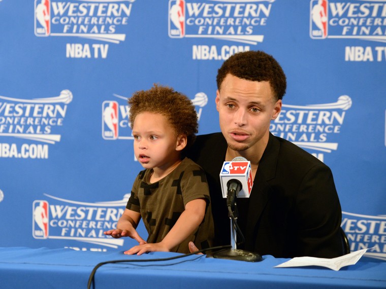 Stephen Curry #30 of the Golden State Warriors and his daughter Riley talking with the media at a press conference after the game against the Houston Rockets during Game One of the Western Conference Finals during the NBA Playoffs on May 19, 2015 at ORACLE Arena in Oakland, California. 
