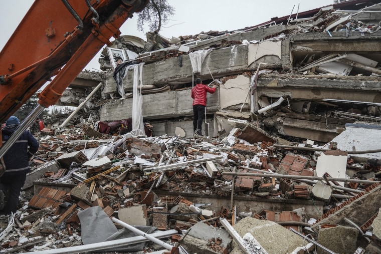 Un hombre busca personas entre los escombros de un edificio destruido en Gaziantep, Turquía, el lunes 6 de febrero de 2023.
