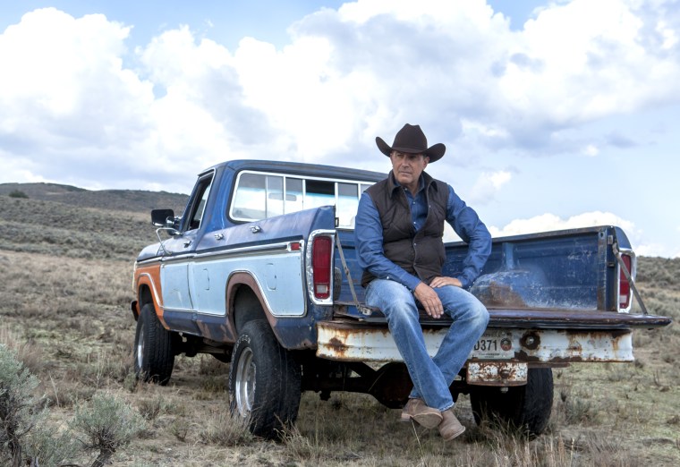 Kevin Costner sits on a truck in "Yellowstone."