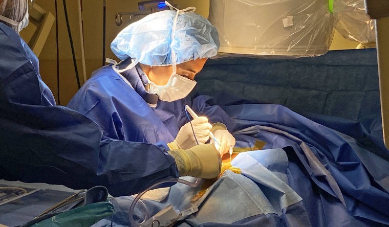 Dr. Kiran Patel preformed a 45-minue surgery on Dennis Bassett to insert a device into his back to help ease his back pain.
