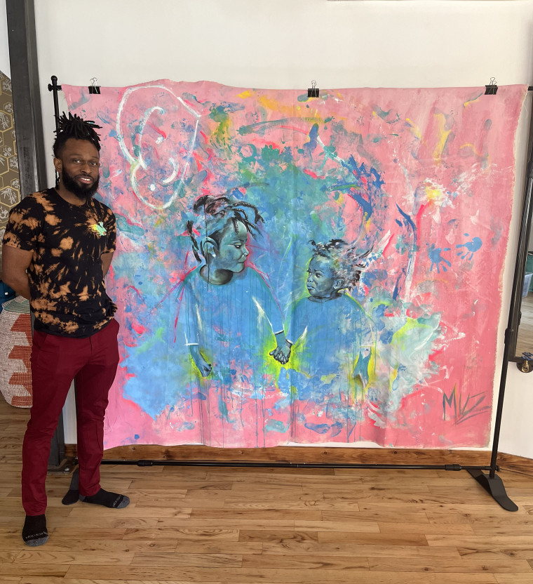 Omari Maynard, pictured next to a portrait of his two children.