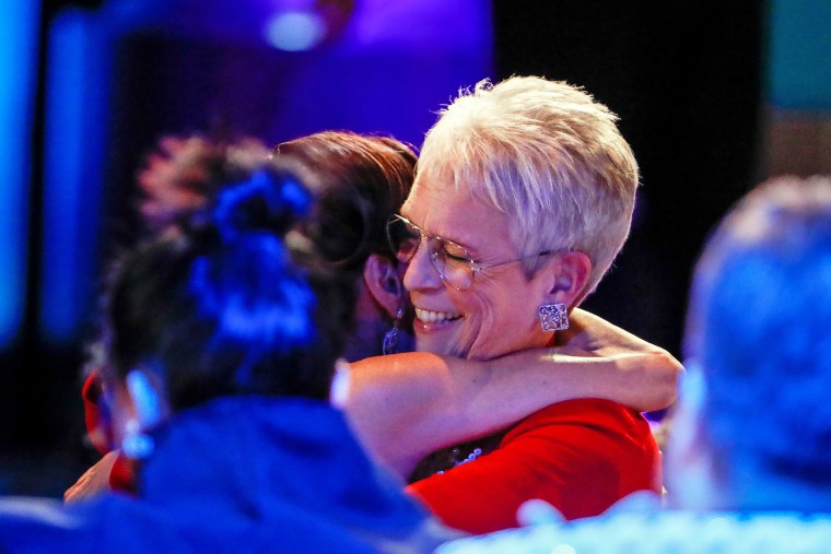 Jamie Lee Curtis hugs Michelle Yeoh before accepting the award for Female Actor in a Supporting Role the at the 29th Annual SAG Awards.