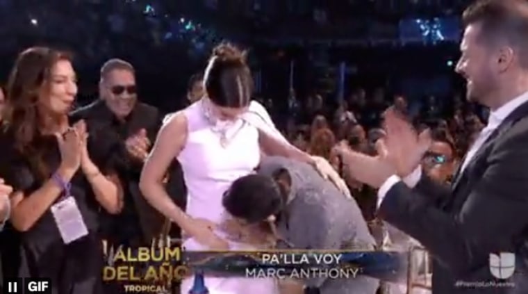 Marc Anthony kissing his wife's belly after winning tropical album of the year at the 2023 awards ceremony.