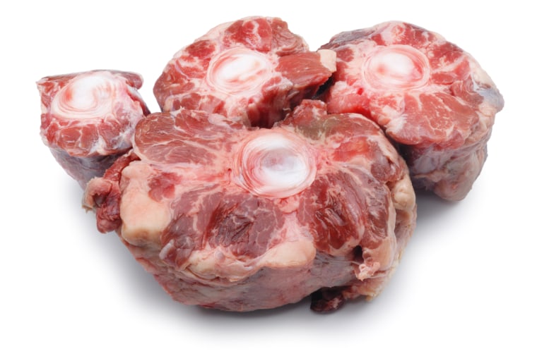 Four pieces of raw oxtail isolated on white.