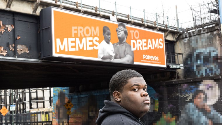 Dieunerst Collin standing in front of his Popeyes billboard in Newark, New Jersey,.