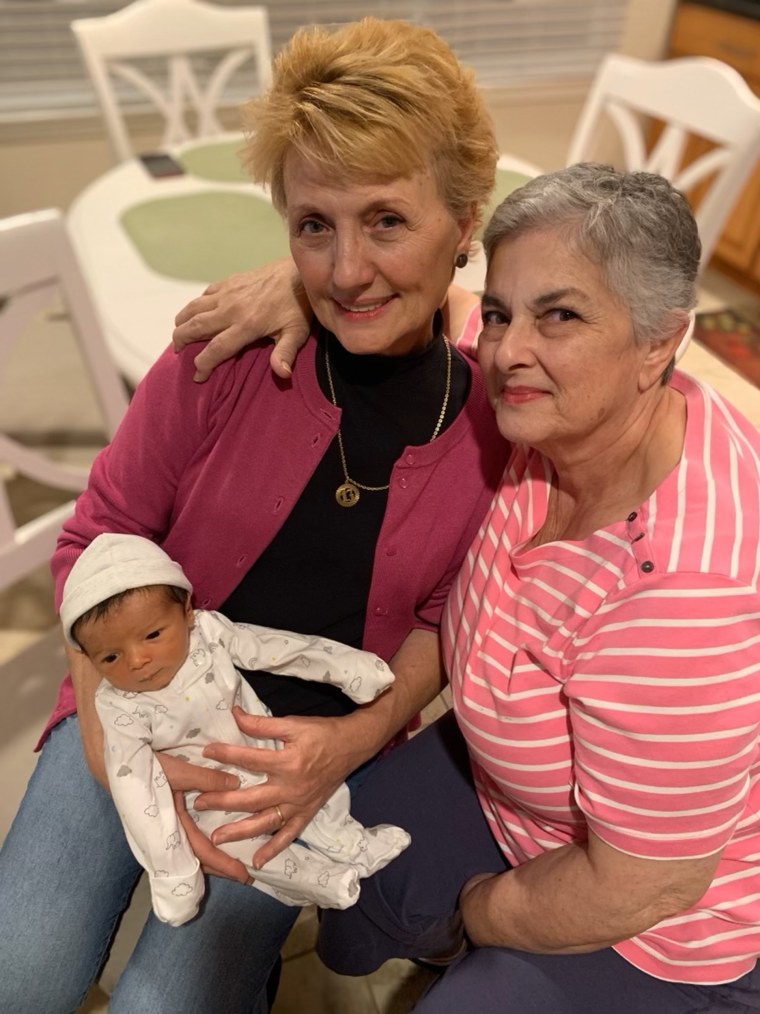 Serafina and Connie, the proud grandmas holding one of their grandbabies.