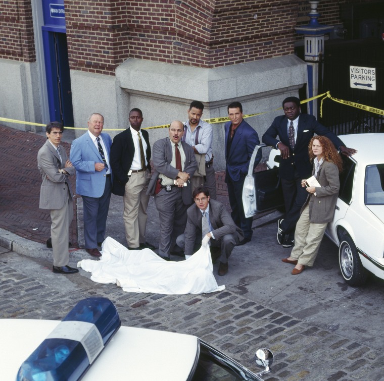 Richard Belzer as Det. John Munch, Ned Beatty as Det. Stanley "The Big Man" Bolander, Andre Braugher as Det. Frank Pembleton, Jon Polito as Det. Steve Crosetti, Clark Johnson as Det. Meldrick Lewis, Kyle Secor as Det. Tim Bayliss (seated, front), Daniel B