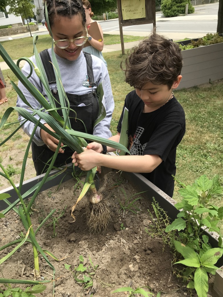 Brooks teaches a student as part of a Black history lesson by FoodCorps and Grow Initiative.