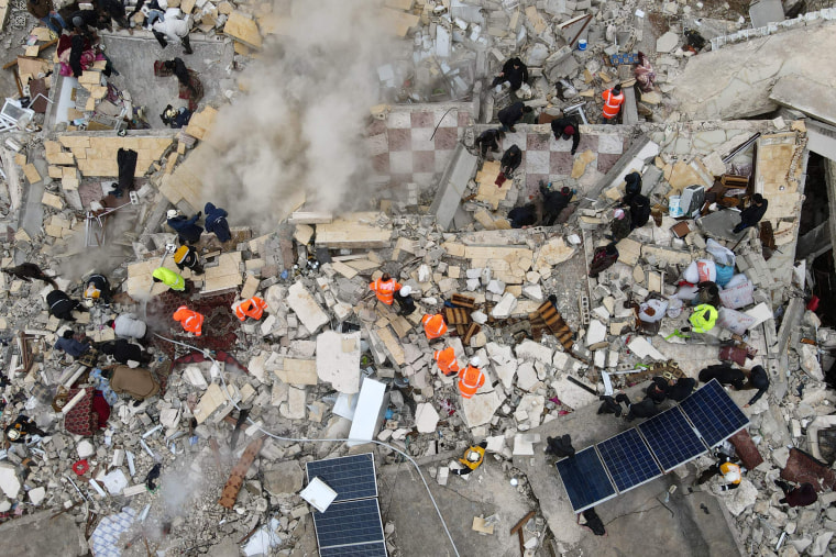 Rescuers search for surivors in Sarmada in Syria's Idlib province. 