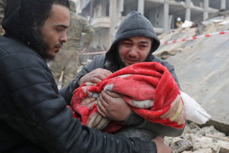 A man carries the body of his son in Jandaris in the rebel-held area of Syria's Aleppo province.