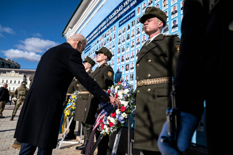Image: President Joe Biden participates in a wreath laying ceremony at the memorial wall outside of St. Michael's Golden-Domed Cathedral during an unannounced visit in Kyiv, Ukraine on Feb. 20, 2023.