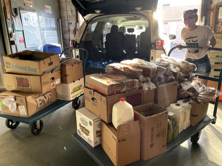 Volunteers load surplus food to donate from the 2022 Super Bowl in Los Angeles, California.