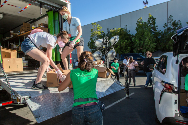 Volunteers load surplus food to donate outside of the 2022 Super Bowl in Los Angeles, California.