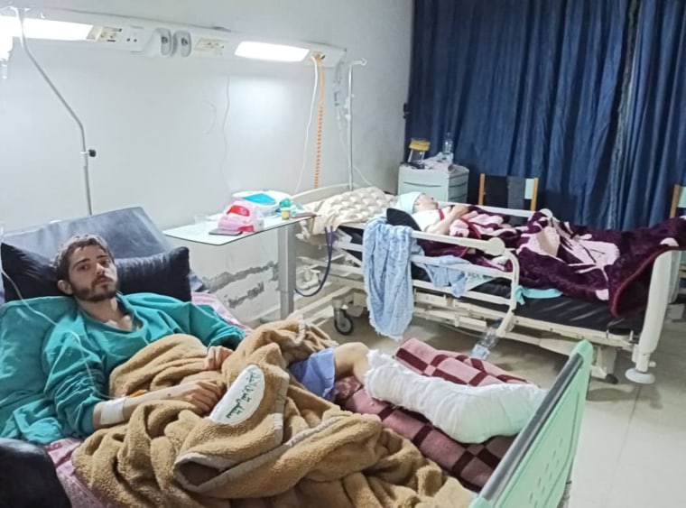 Ibrahim Zakaria and his mother, Duha Nurallah, recovering in a Syrian hospital.