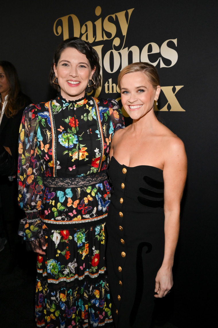 Author Taylor Jenkins Reid and Reese Witherspoon posing for a photo at the premiere.