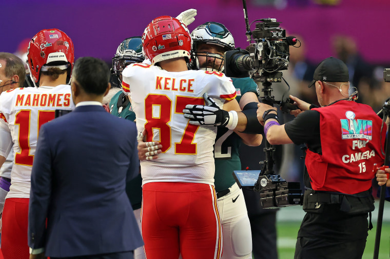 Travis Kelce of the Kansas City Chiefs hugs Jason Kelce of the Philadelphia Eagles.