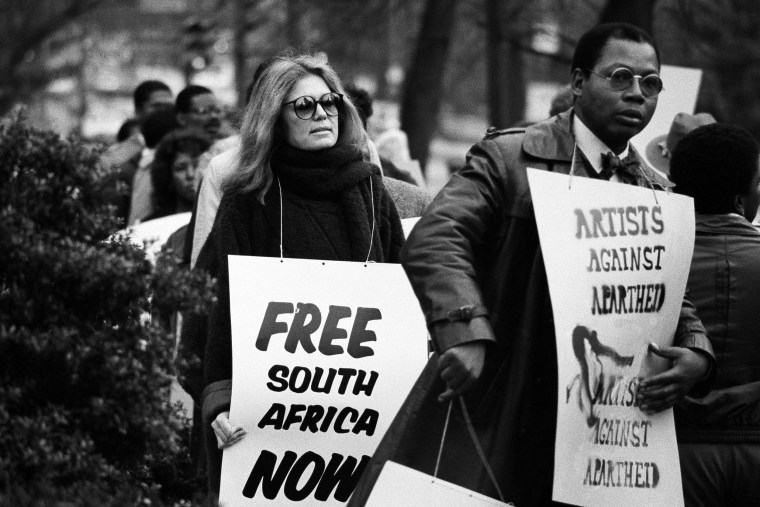 Gloria Steinem walks a picket line outside the South African Embassy in Washington on Dec. 20, 1984.