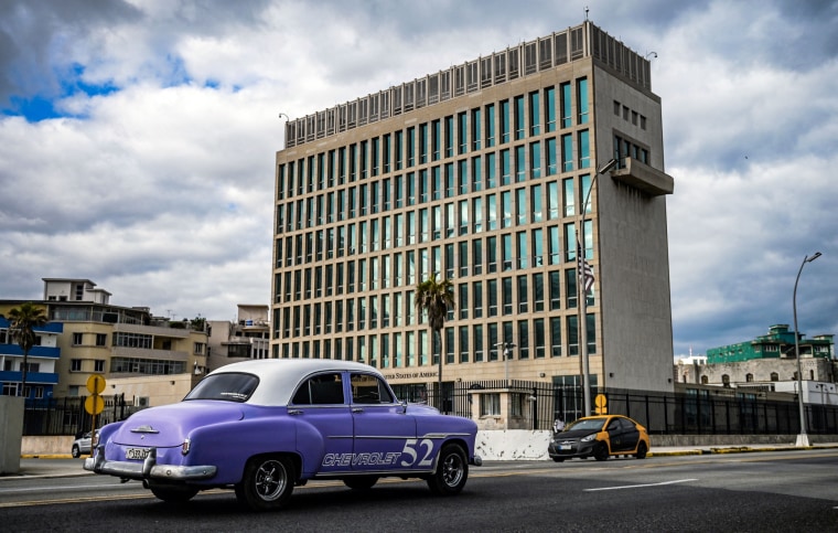 An old American car passes by the U.S. embassy in Havana on May 3, 2022.