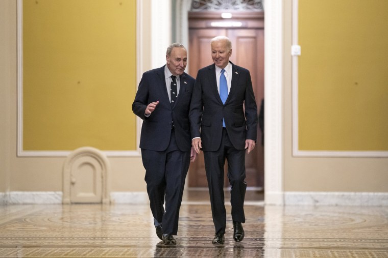 President Joe Biden talks with Senate Majority Leader Chuck Schumer as Biden arrived to talk with Senate Democrats at the Capitol on March 2, 2023. 