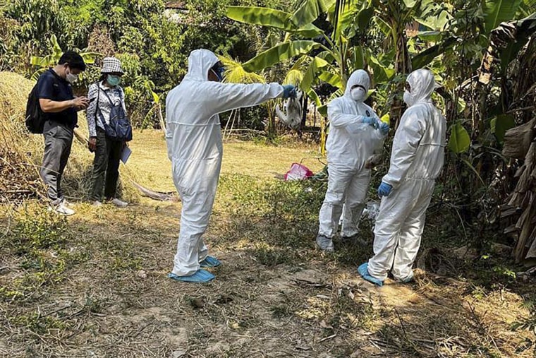 Cambodia health experts spray disinfectant at a village in Prey Veng on Feb. 24, 2023.