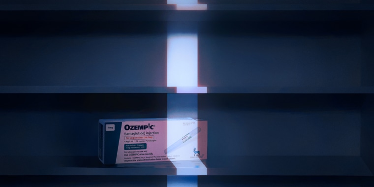 Conceptual illustration of a single box of Ozempic on an empty cabinet shelf, with a thin strip of light illuminating it.