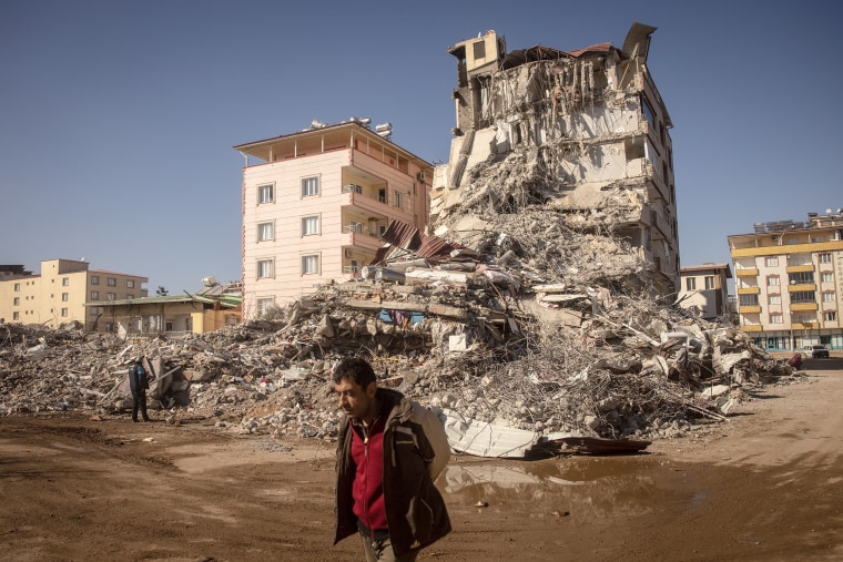 NURDAGI, TURKEY - FEBRUARY 13: A man walks past a  destroyed building on February 13, 2023 in Nurdagi, Turkey. A 7.8-magnitude earthquake hit near Gaziantep, Turkey, in the early hours of Monday, followed by another 7.5-magnitude tremor just after midday. The quakes caused widespread destruction in southern Turkey and northern Syria and has killed more than 30,000 people.   (Photo by Chris McGrath/Getty Images) *** BESTPIX ***
