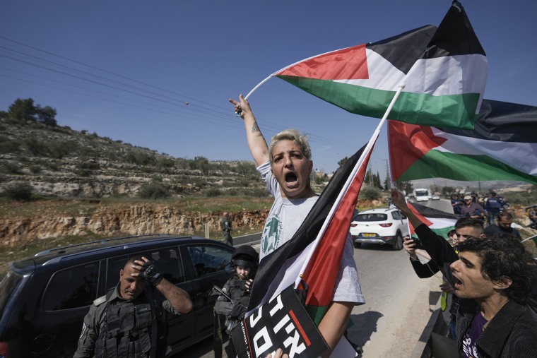 Israeli border police officers block hundreds of Israeli left-wing activists from staging a solidarity rally next to the West Bank town of Hawara on March 3, 2023. 