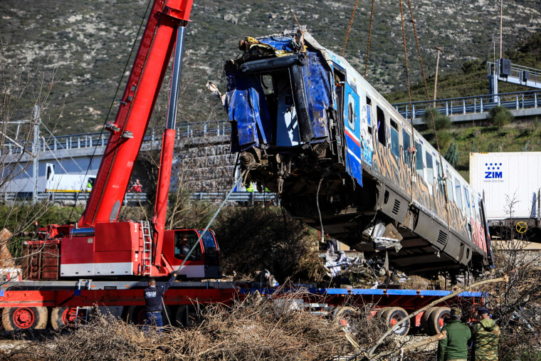 Crews remove a train carriage from the crash site in the valley of Tempi, near Larissa, Greece, on March 3, 2023.